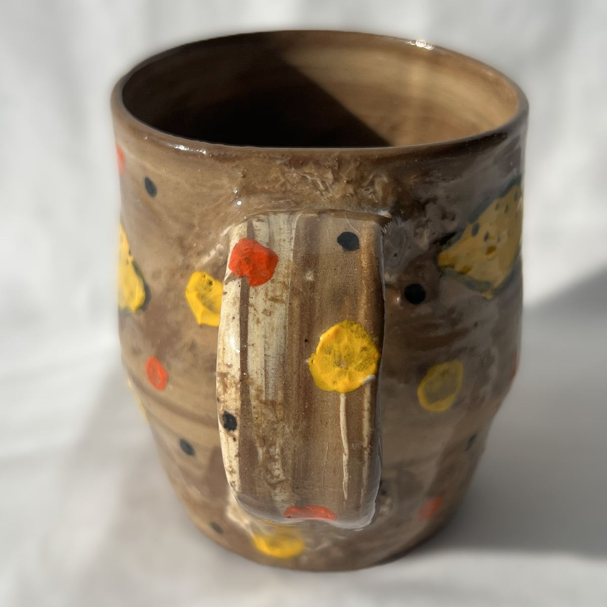brown Ceramic mug with lemon design on a white background