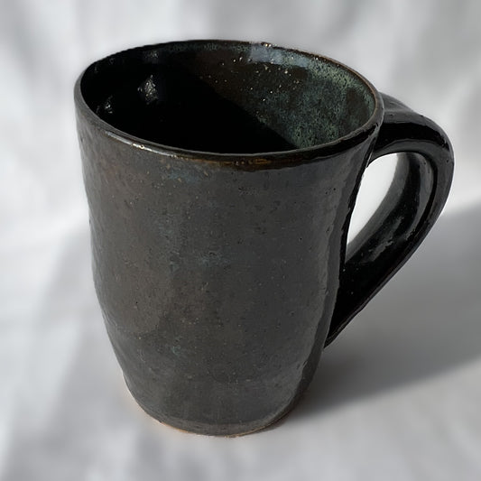 smooth and slightly textured speckled black and dark green ceramic mug