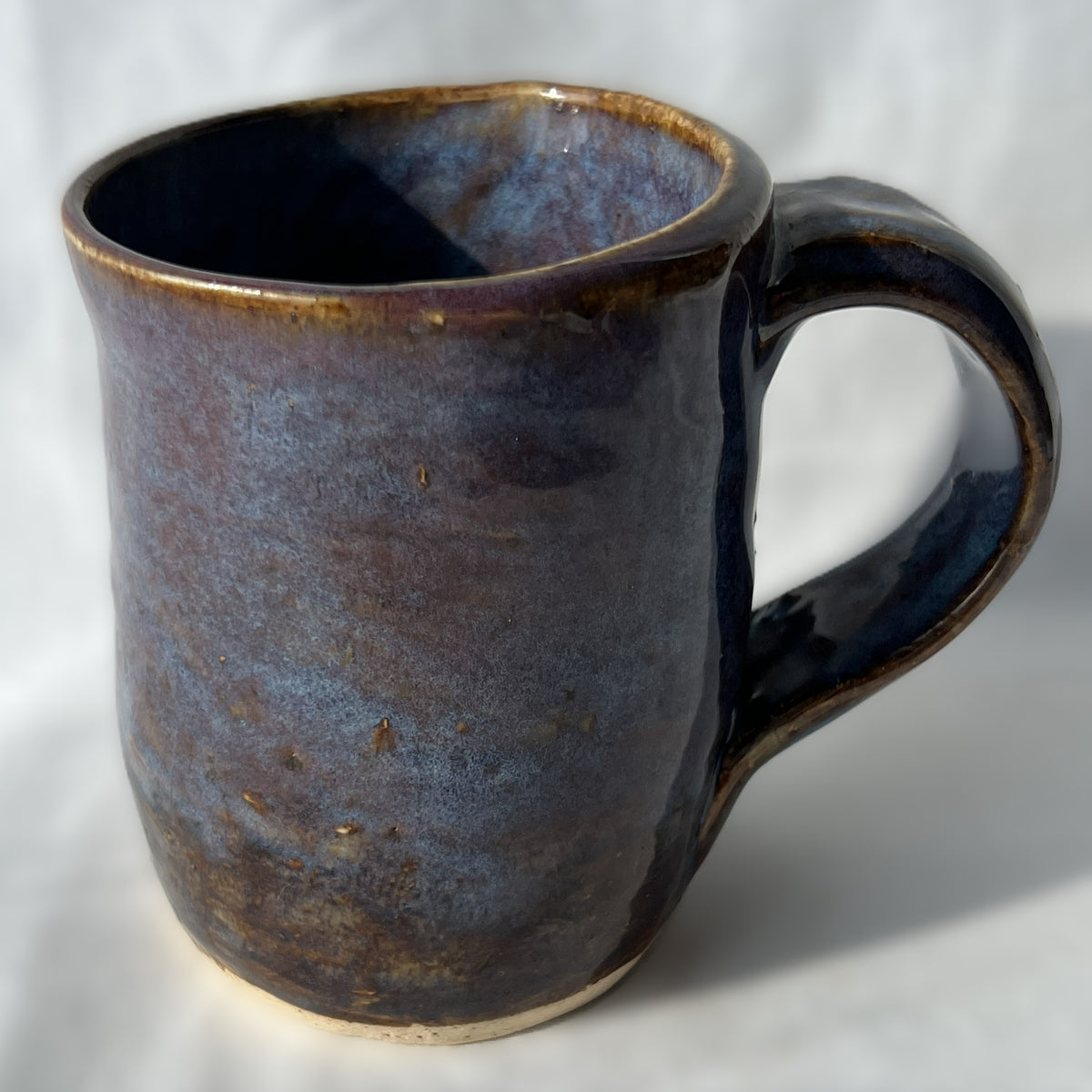 Ceramic mug with a smooth brown purple surface