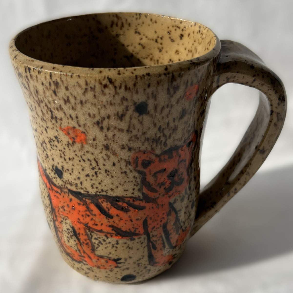 Speckled ceramic mug with 'Go get 'em TIGER!' text on a brown background