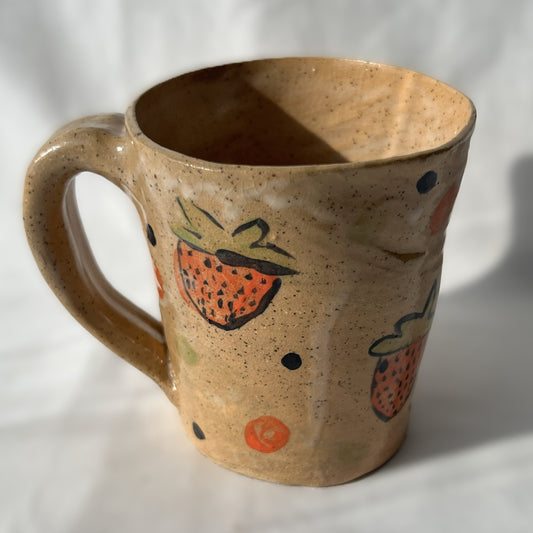 Ceramic mug with strawberry design on a speckled tan background