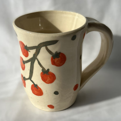 Ceramic mug with tomato design on a white background