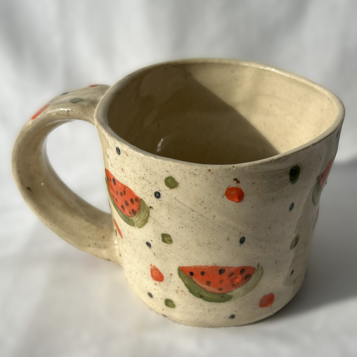 Ceramic mug with watermelon pattern on a white background