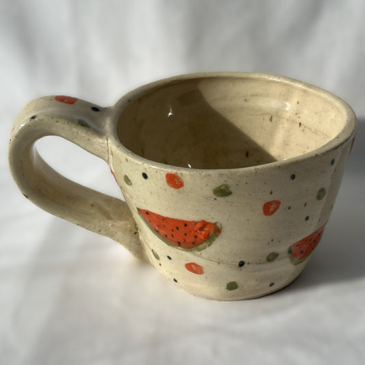 Ceramic mug with watermelon designs on a white background