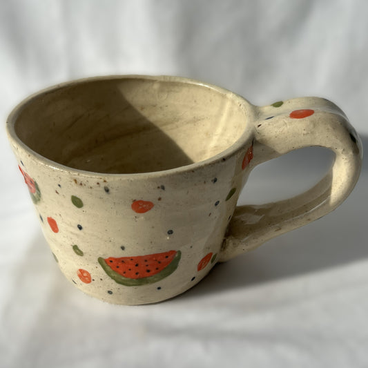 Ceramic mug with watermelon design on a white background