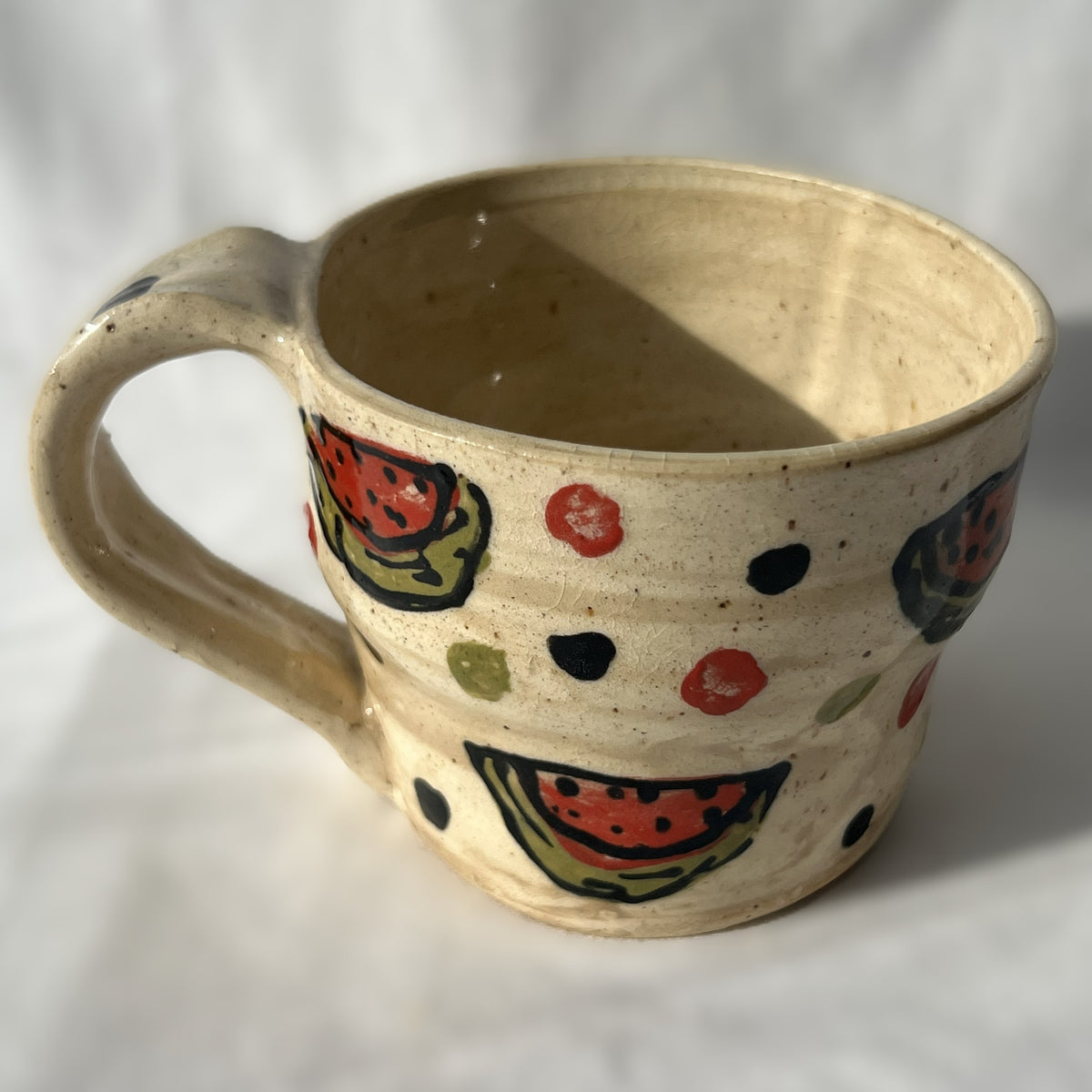 Ceramic mug with watermelon pattern on a white background