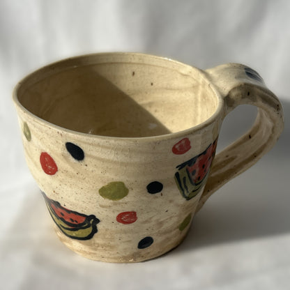Ceramic mug with watermelon designs on a white background