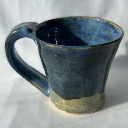 Blue ceramic mug on a white background with smooth surface