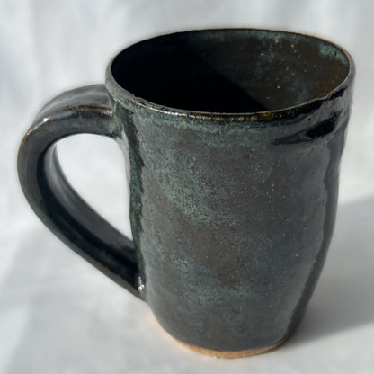 smooth slightly speckled texture dark green and black ceramic mug
