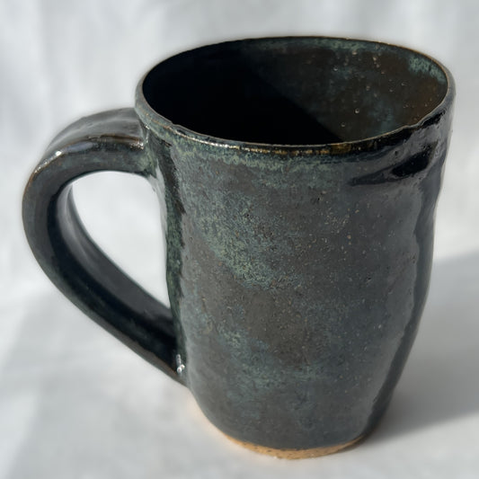 smooth slightly speckled texture dark green and black ceramic mug