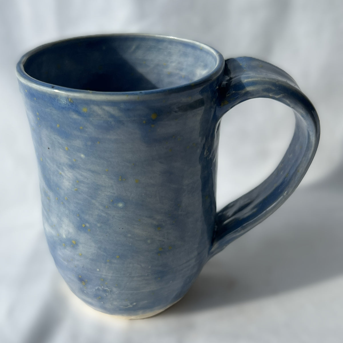 Blue ceramic mug on a white background with smooth surface