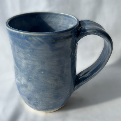 Blue ceramic mug on a white background with smooth surface