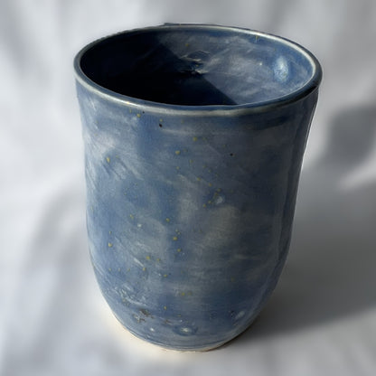 Blue ceramic cup on a white background with smooth surface