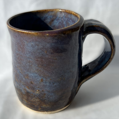 Ceramic mug with a smooth brown purple surface