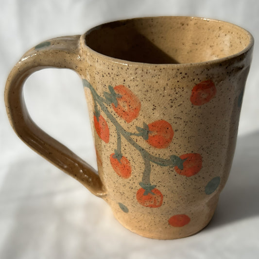 Speckled Ceramic mug with tomato design on a tan background