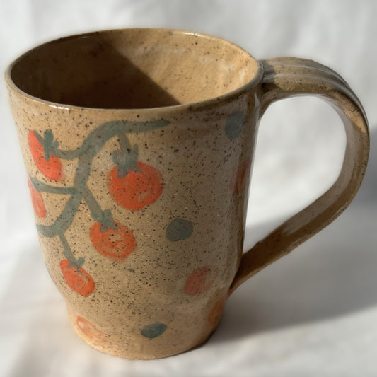 Speckled Ceramic mug with tomato design on a tan background