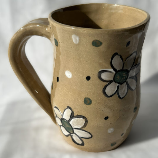 Brown ceramic mug with floral designs 