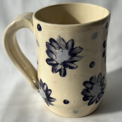 ceramic mug with blue floral patterns on a white background