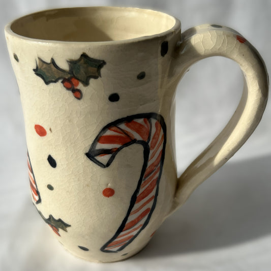 Ceramic mug with a candy cane design on a white background