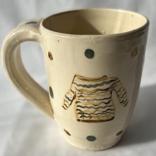 Ceramic mug with a sweater design on a white background