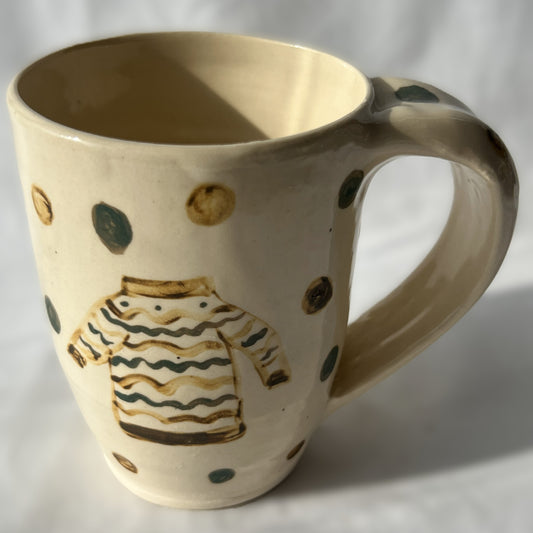 Ceramic mug with a sweater design on a white background