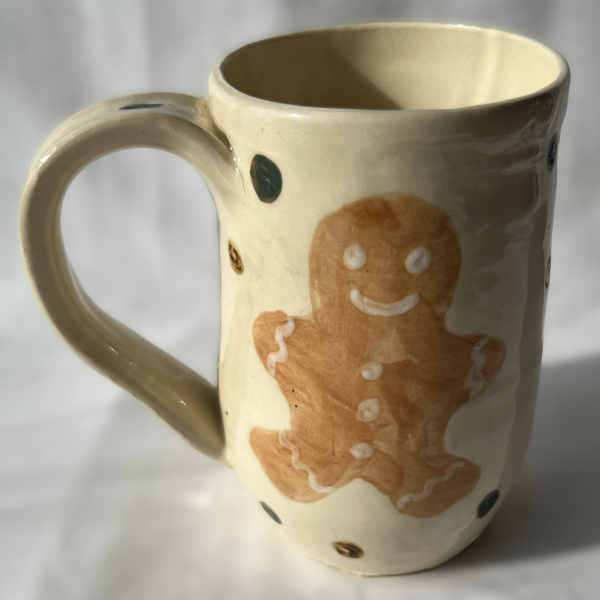 Ceramic mug with a gingerbread man design on a white background
