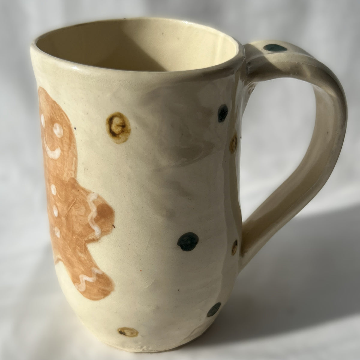 Ceramic mug with a gingerbread man design on a white background
