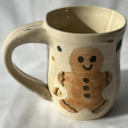 Ceramic mug with a gingerbread man design on a white background
