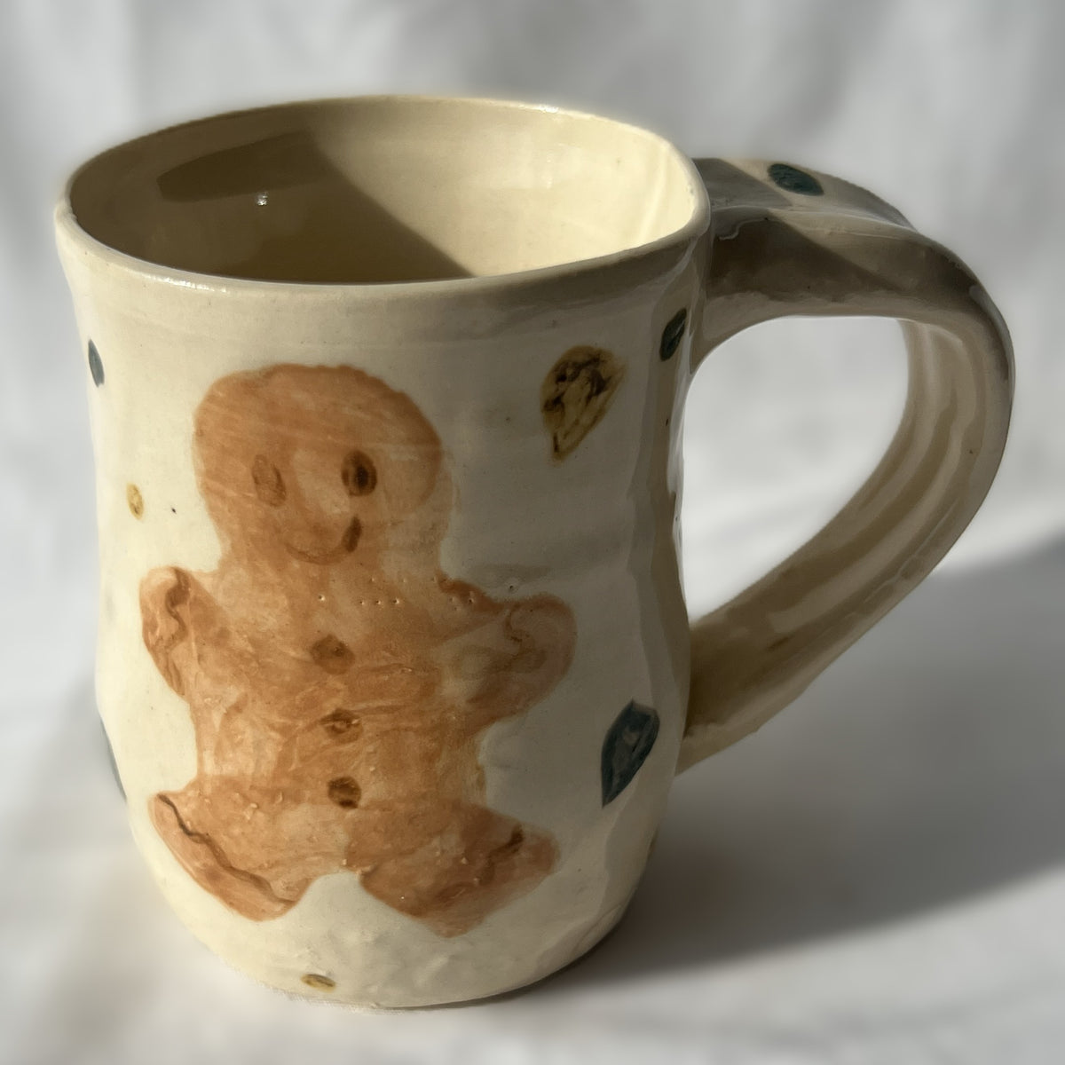 Ceramic mug with a gingerbread man design on a white background