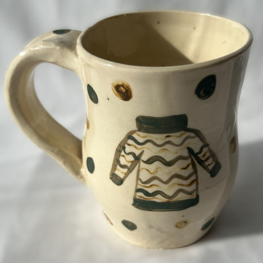 Ceramic mug with a sweater design on a white background