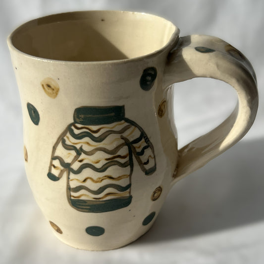 Ceramic mug with a sweater design on a white background