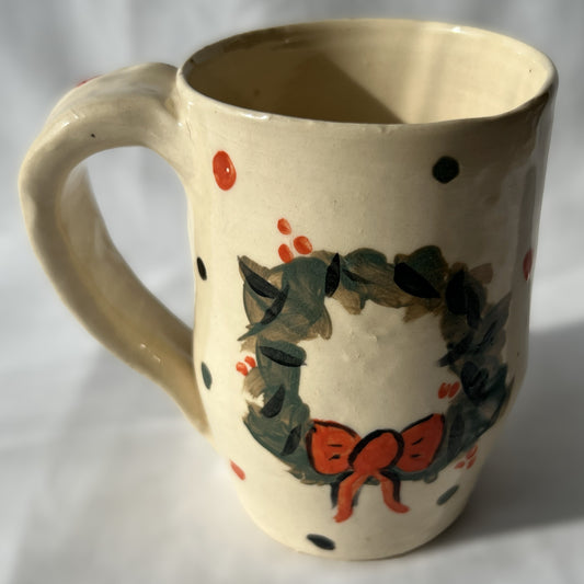 Ceramic mug with wreath design on a White background