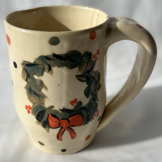 Ceramic mug with wreath design on a White background