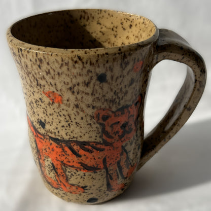 Speckled ceramic mug with 'Go get 'em TIGER!' text on a brown background