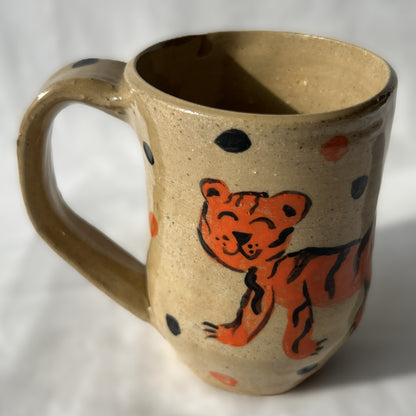 Ceramic mug with a tiger design on a Tan background