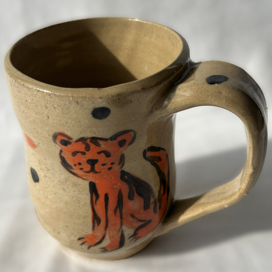 Ceramic mug with a tiger design on a Tan background