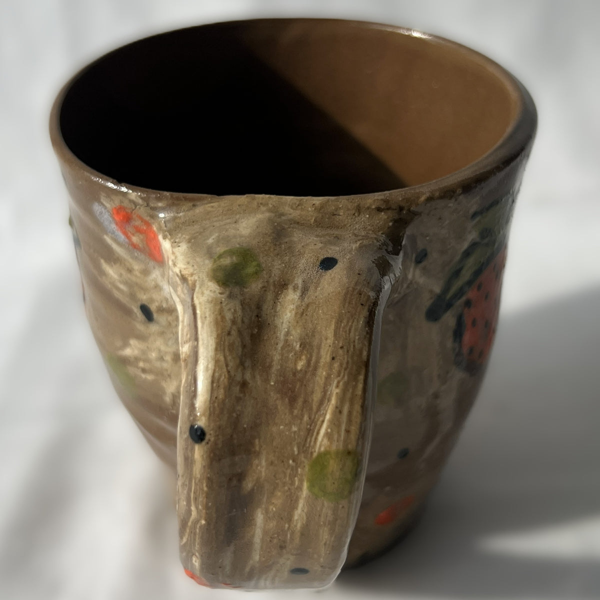 brown Ceramic mug with strawberry design on a white background