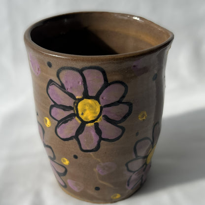 Smooth Ceramic cup with floral designs on a brown background