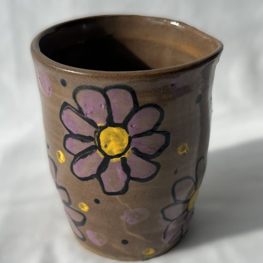 Smooth Ceramic cup with floral designs on a brown background