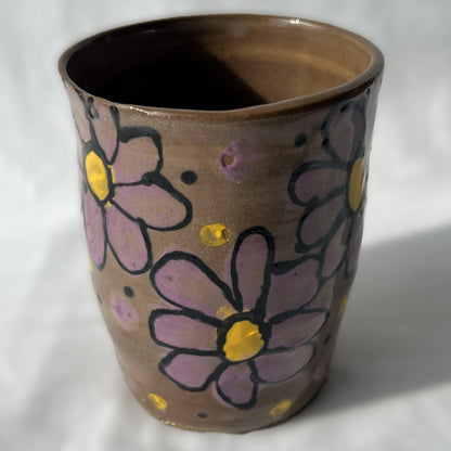 Smooth Ceramic cup with floral designs on a brown background