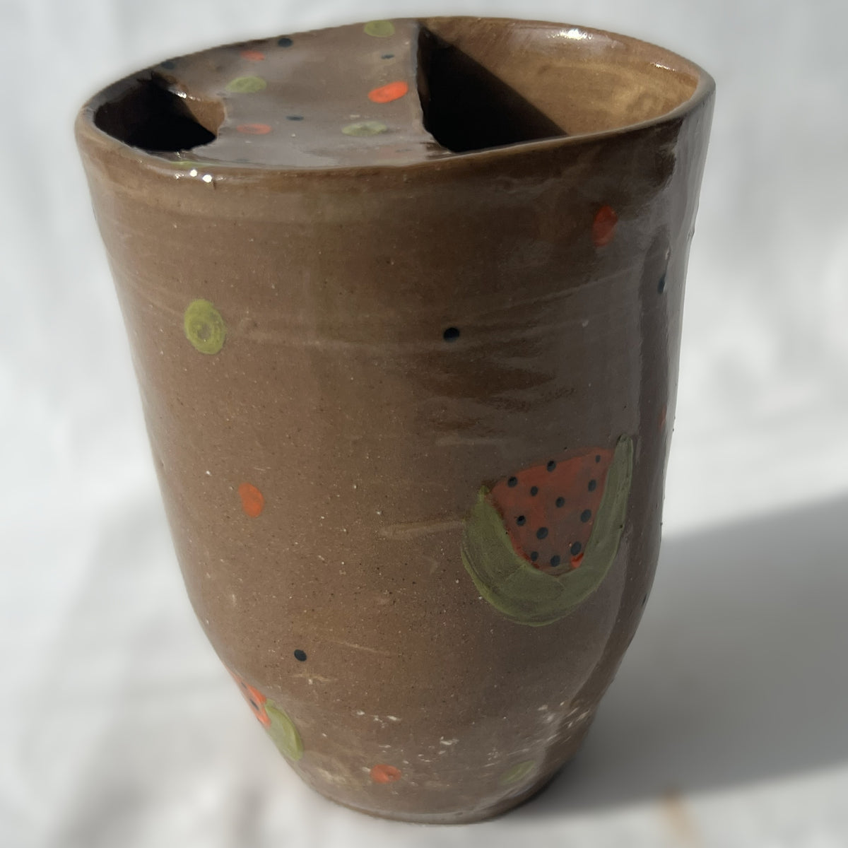 Ceramic handless partial lidded cup, brown with watermelons on it