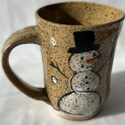 Speckled ceramic mug with a snowman design
