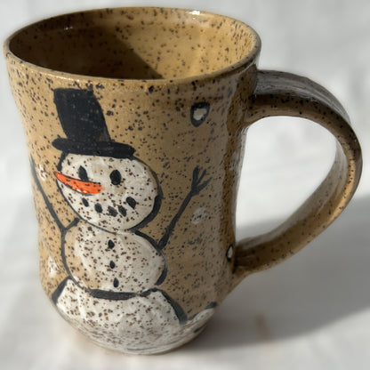Speckled ceramic mug with a snowman design