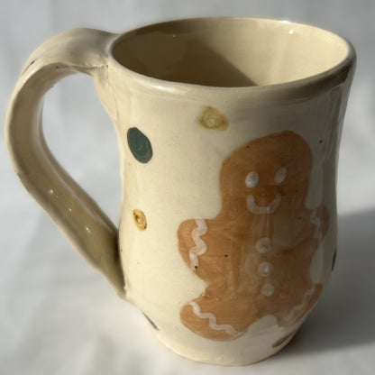 Ceramic mug with a gingerbread man design on a white background