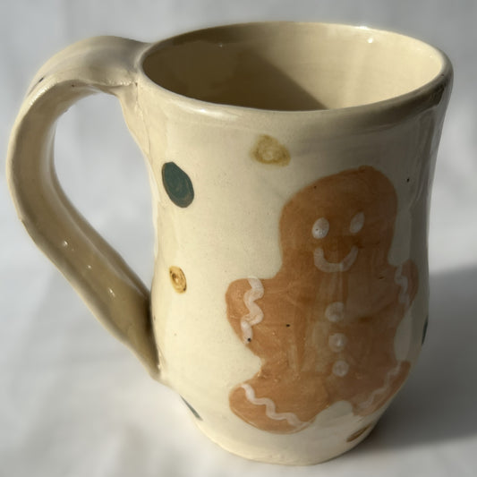 Ceramic mug with a gingerbread man design on a white background