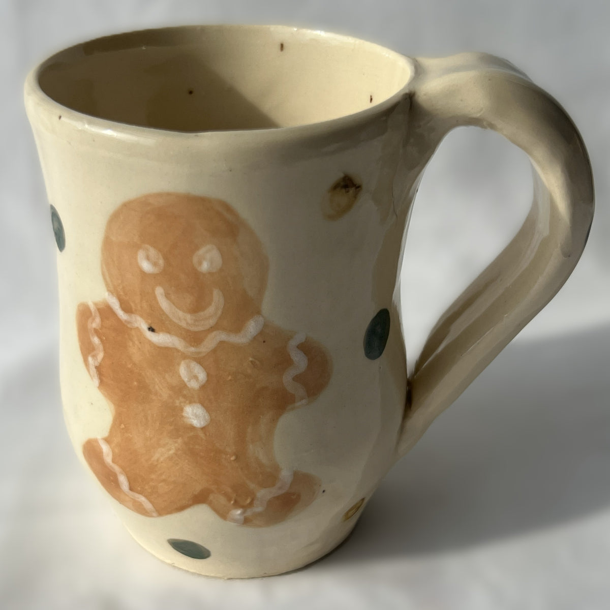 Ceramic mug with a gingerbread man design on a white background