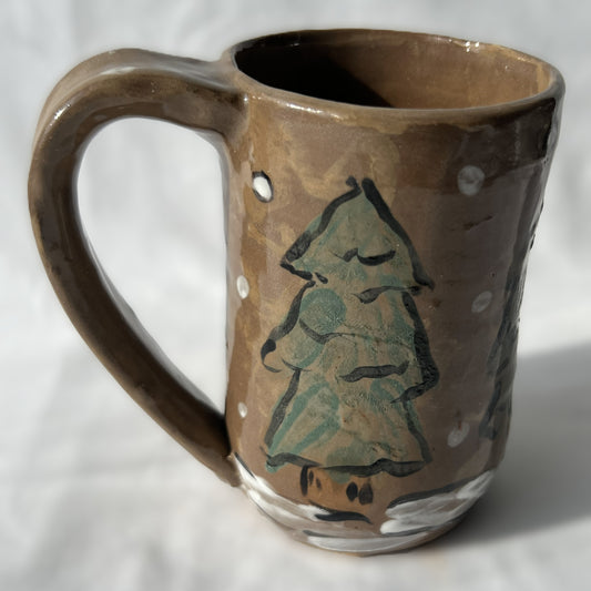 Ceramic mug with a tree design on a brown background
