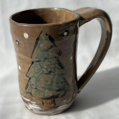 Ceramic mug with a tree design on a brown background