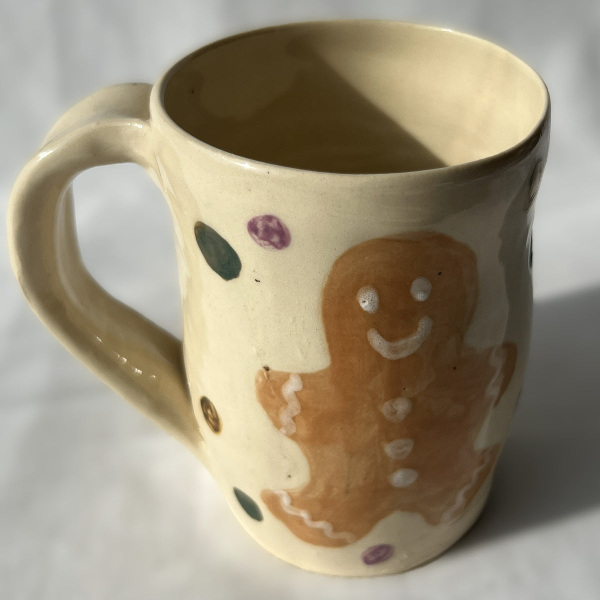 Ceramic mug with a gingerbread man design on a white background