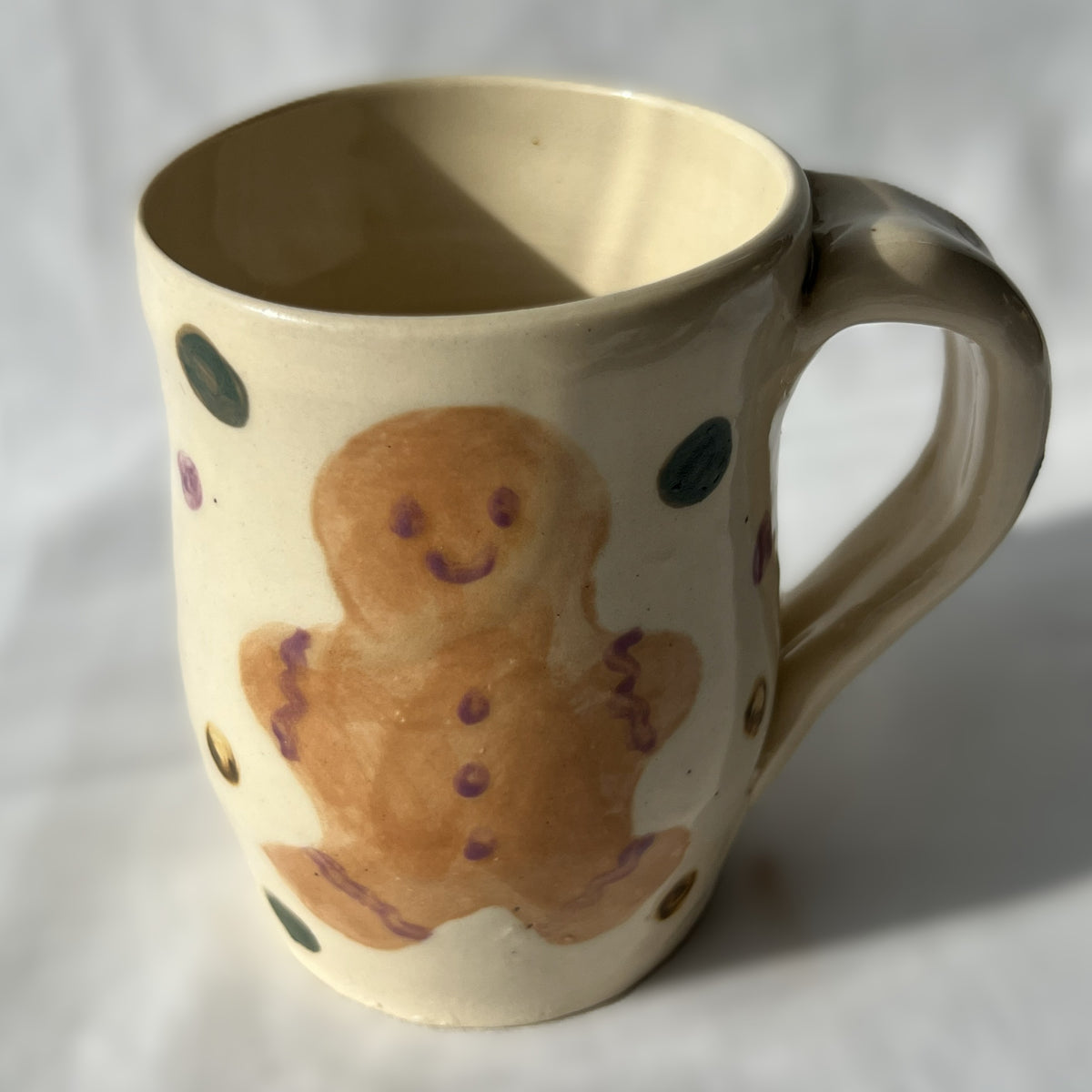 Ceramic mug with a gingerbread man design on a white background